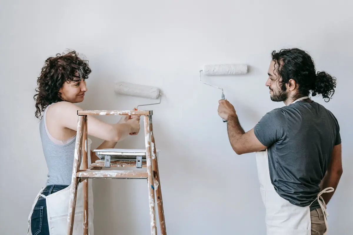 People painting a wall together — painting help in Fort Wayne