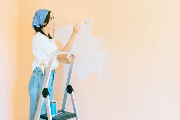 Interior painting in Fort Wayne: painter on a stepladder rolling a wall